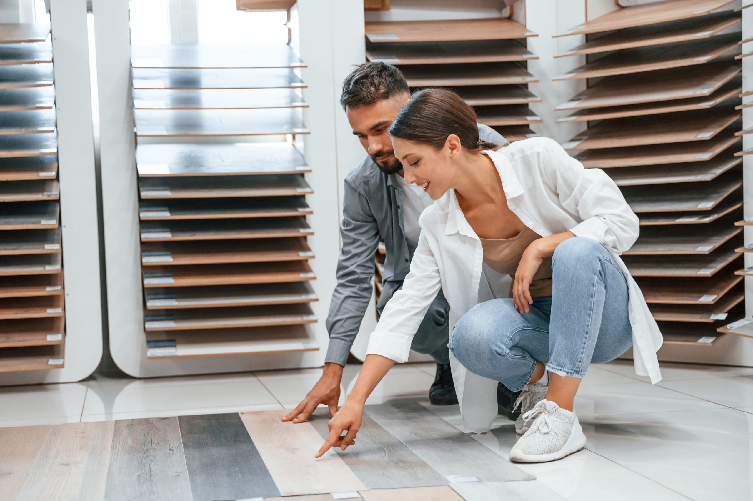 man and woman choosing new flooring in showroom